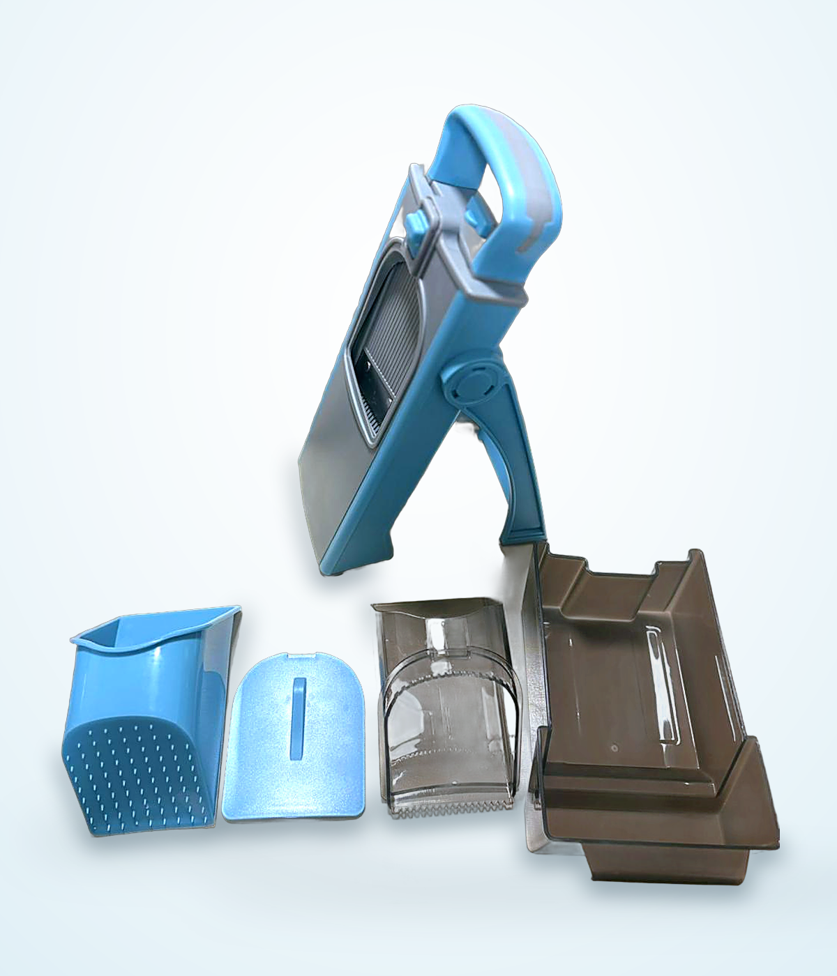 LDHER vegetable cutter shown with all parts separated: body, strainer, pusher, blade insert and container